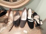 several pairs of women ' s shoes are lined up on a table