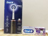 a box of toothbrushes sitting on the floor next to a box of toothpaste