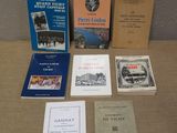 several books are sitting on a table next to each other