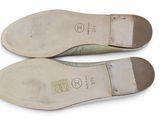 pair of women ' s shoes on a white surface with a white background