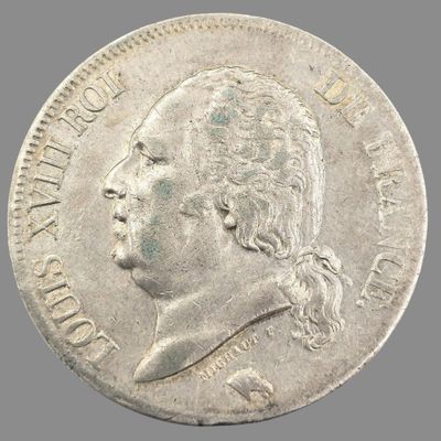 Gros plan sur une pièce de monnaie portant le visage d'un homme