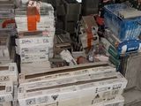 a pile of boxes sitting on the floor in a warehouse