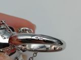 a person holding a silver ring with a diamond on it