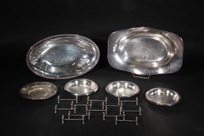 silverplated dishes and trays on a black background