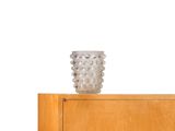 a vase sitting on top of a wooden cabinet