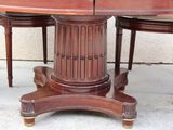 a wooden table with four chairs around it