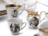 a lot of cups and saucers that are sitting on a table