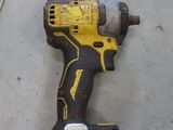 a cordless drill on the floor next to a piece of metal