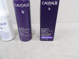 a bottle of caudalie and a bottle of lotion on a table