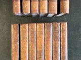 several old books are stacked on top of each other on a table