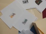 many envelopes with stamps on them on a table