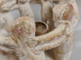 figurines of a group of people holding hands in a circle