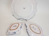 two plates and a bowl sitting on a table