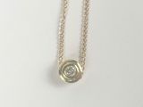 a gold necklace with a white diamond on a chain