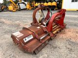 a close up of a red machine on a dirt field