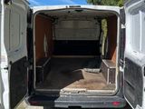a white van that is parked in the dirt