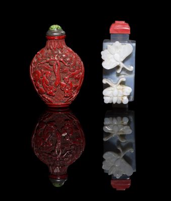 two chinese carved glass snuff bottles with flowers on them