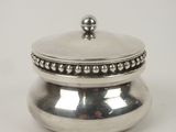 silver plated box with beaded lid on a white background