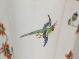 a close up of a vase with a bird on it