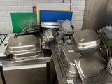 many pans and pans on the counter in the kitchen