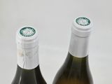 two bottles of wine sitting next to each other on a table