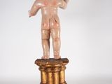 an image of a statue of a child on a pedestal