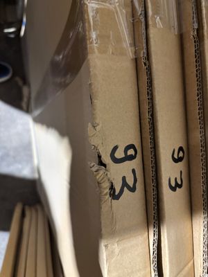 a stack of cardboard boxes with arabic writing on them