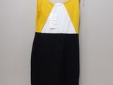 a yellow and black dress hanging on a white hanger