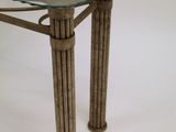 a glass table with a metal frame and a glass top