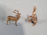 two figurines of animals on the hood of a car