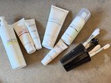 many different types of skin care products laid out on the floor