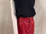 red leather skirt with black top and white shirt on a mannequin mannequin mannequin mannequin mannequin mannequin mannequin