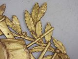 a gold leaf decoration on the wall of a room