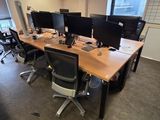 many computers on the desks in this office