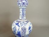 a blue and white vase sitting on a table