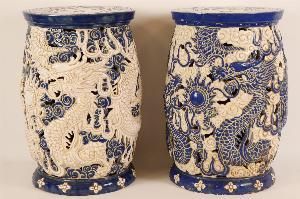 pair of blue and white vases sitting on a white surface