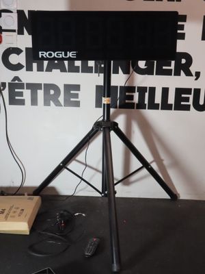 a television on a tripod in front of a wall