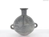 a gray vase that is sitting on a table
