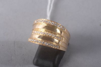 a gold ring with diamonds on top of a black stone