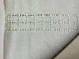 a close up of a piece of cloth with writing on it