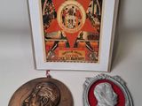 two medals and a card with a picture of a man and a woman