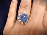 an image of a woman ' s hand with a ring on it