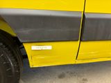 a close up of a yellow truck door with a sticker on it