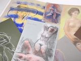 many different colored drawings of a woman on a table