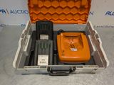 an orange case with a remote control and other items in it