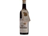 bottle of wine with a tag on it sitting on a white surface