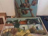 a picture of a painting on a table next to a picture of a guitar