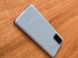 the back of a white samsung s10 on a wooden table