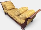 a chaise lounger with three pillows on top of it