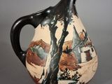 a black and white vase with a painting on it